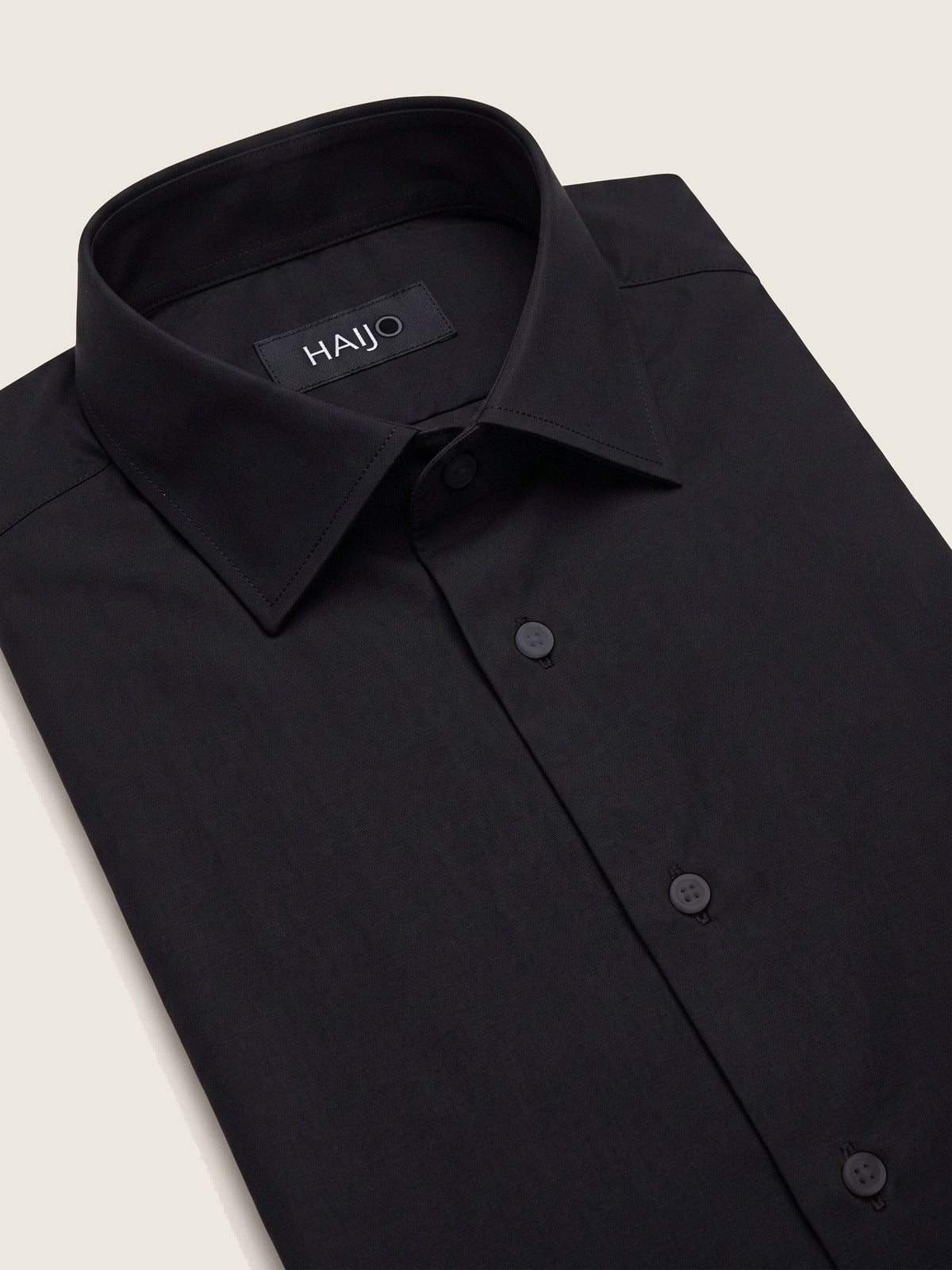 Classic Shirt, Black Comfort, folded, showing the collar and the Hajjo label