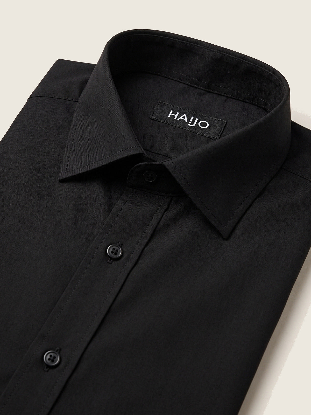 Classic Shirt, Black Slim, folded, showing the collar and the Hajjo label