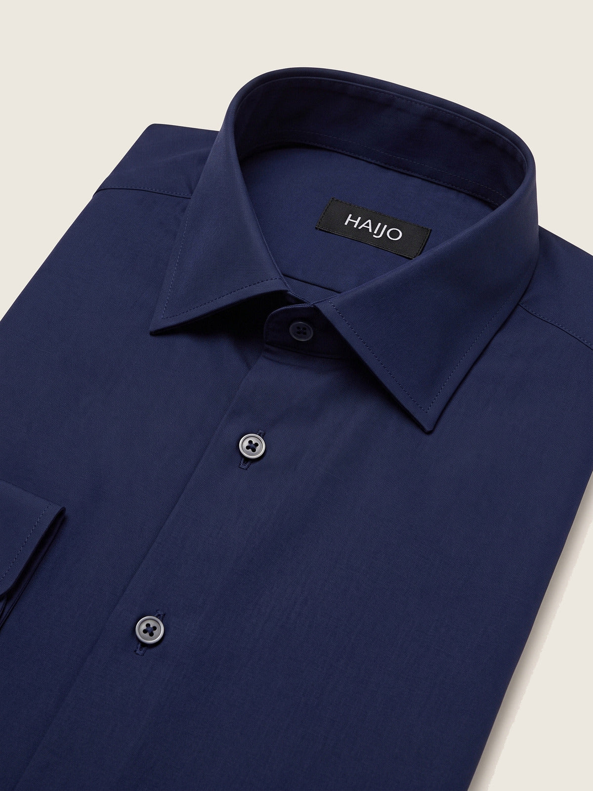 Classic Shirt, Navy Slim, folded, showing the collar and the Hajjo label