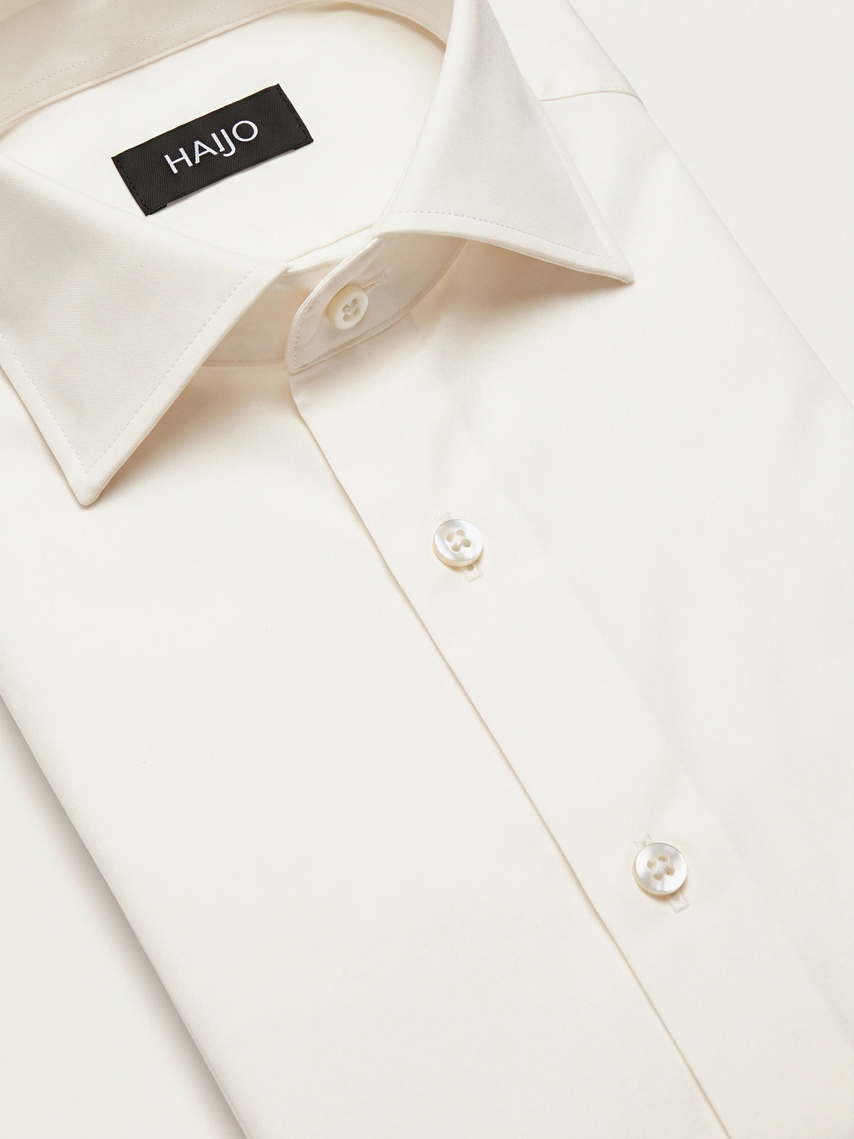 Classic Shirt, Off White Slim, folded, showing the collar and the Hajjo label