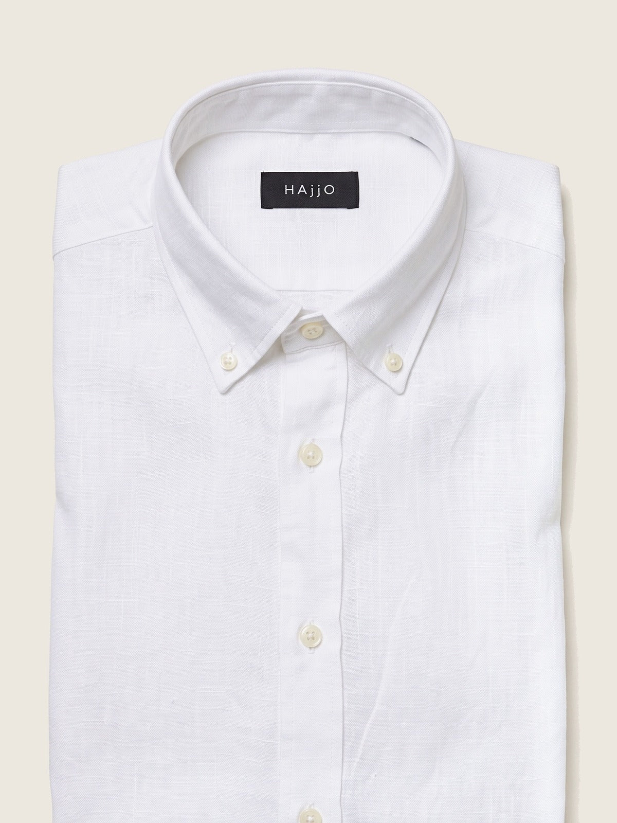 Linen Shirt, White, folded, showing the collar and the Hajjo label